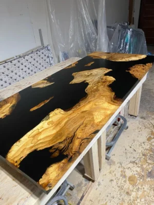 Maple burl epoxy river table shown from side angle 2