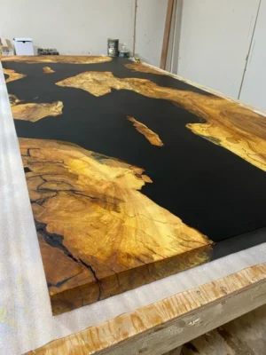 Maple burl epoxy river table shown from side angle